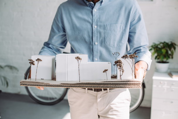 cropped image of architect holding architecture model in office - Foto, Imagen