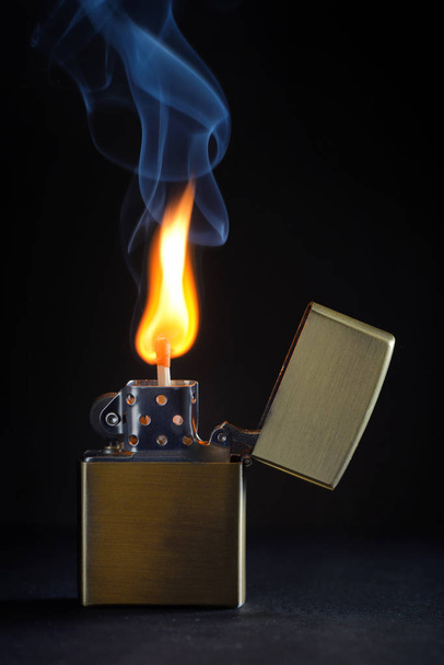 Abstract golden metal lighter and smoke - Photo, Image