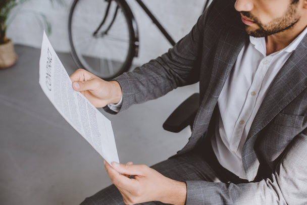 cropped image of businessman reading contract in office - Photo, Image