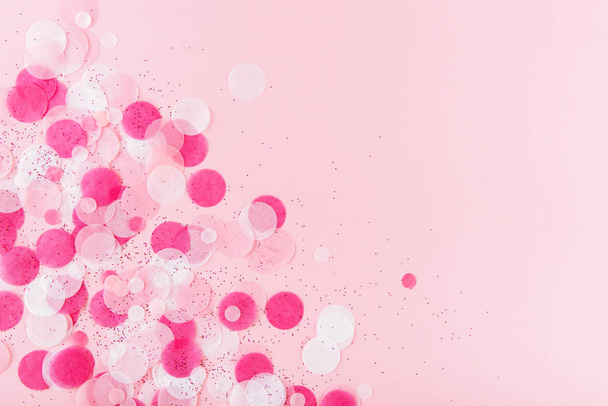 Pink Colorful festive confetti. Flat lay style. Top view - Foto, imagen