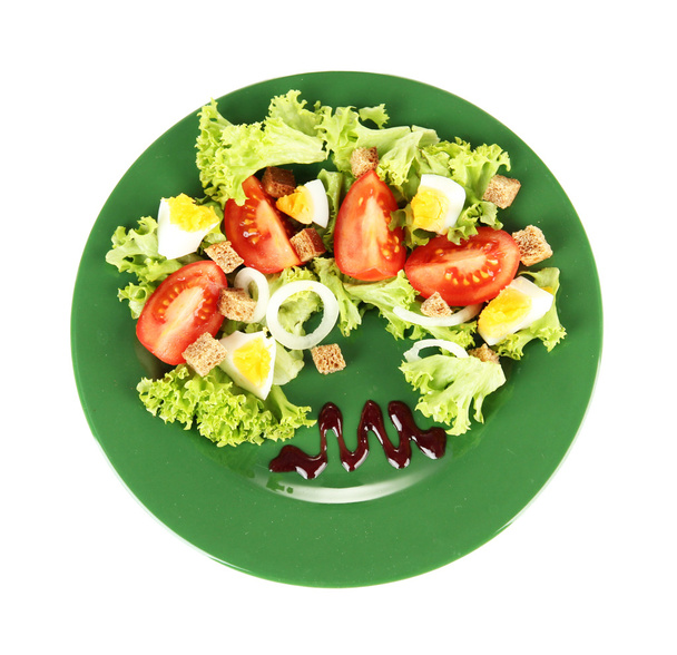 Fresh mixed salad with eggs, tomato, salad leaves and other vegetables on color plate, isolated on white - Photo, Image