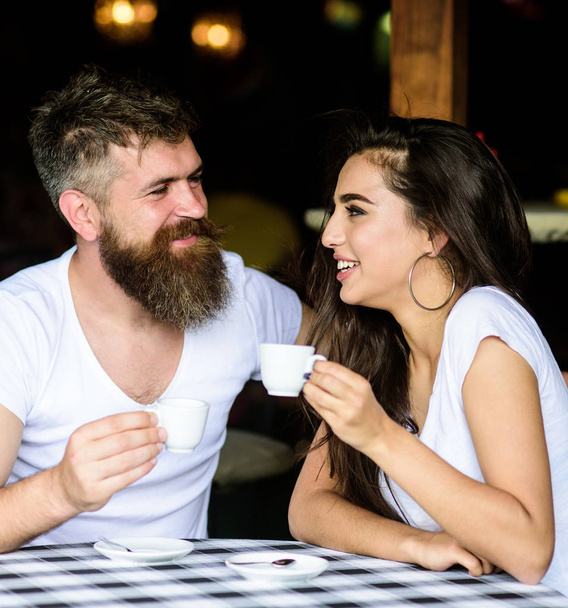 Couple enjoy hot espresso. Couple in love drink black espresso coffee in cafe. Romantic date in cafe. Drinking black coffee improves your mood and thus makes you happy. Pleasant coffee break - Foto, Bild