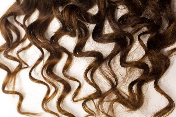 Кудрявые каштановые волосы выделены на белом
 - Фото, изображение