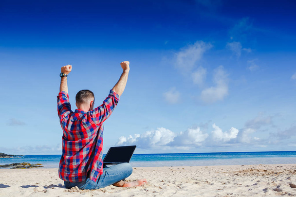 Happy exited man with raised hands up celebrate success in job or great news in front of laptop - Foto, Imagem