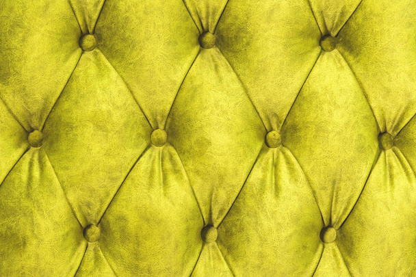 Velor surface of sofa close-up. Training equipment-velor mats tightened with buttons. Yellow chesterfield style quilted upholstery background close up - Фото, изображение