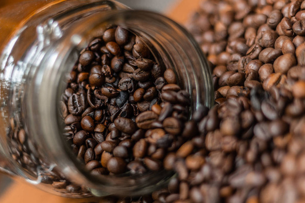 Kávová zrna, sype z průhledné sklenice. Zátiší - Fotografie, Obrázek