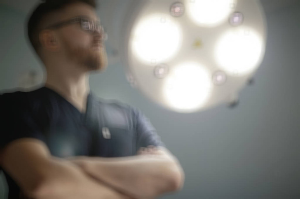 confident male surgeon in medical uniform posing on blurred background , concept of medicine and surgery - Fotoğraf, Görsel