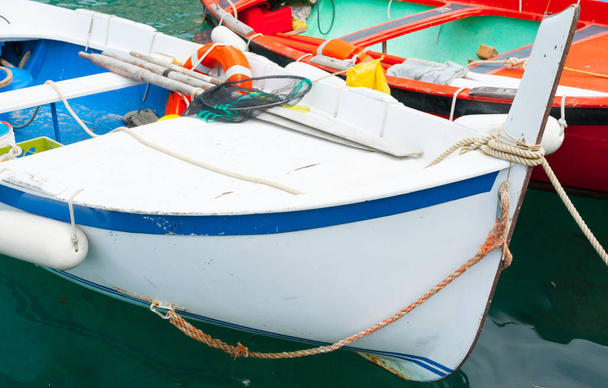 Close-up two moored traditional European fishing boats white and red hulls. - Photo, Image