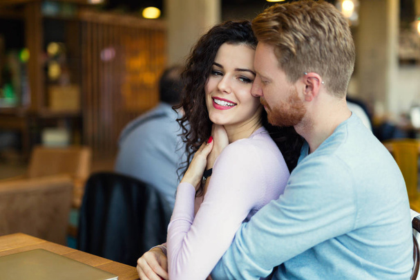 Young happy couple on date in coffee shop having romantic times - Photo, image