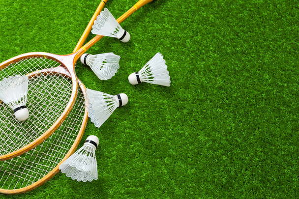 Wooden badminton rackets on green grass - Φωτογραφία, εικόνα