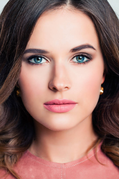 Young woman with makeup and brunette hairstyle. Beautiful female face closeup, fashion portrait - Φωτογραφία, εικόνα