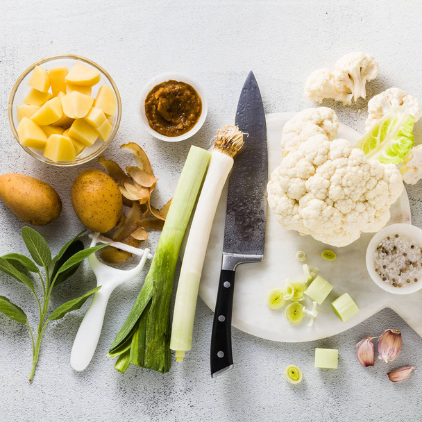ingredients from vegetables for soup on a table with spices and a chef's knife. culinary photo for recipes step by step - Fotoğraf, Görsel