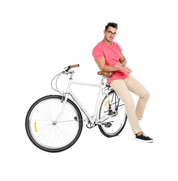 Handsome young hipster man with bicycle on yellow background - Foto, afbeelding