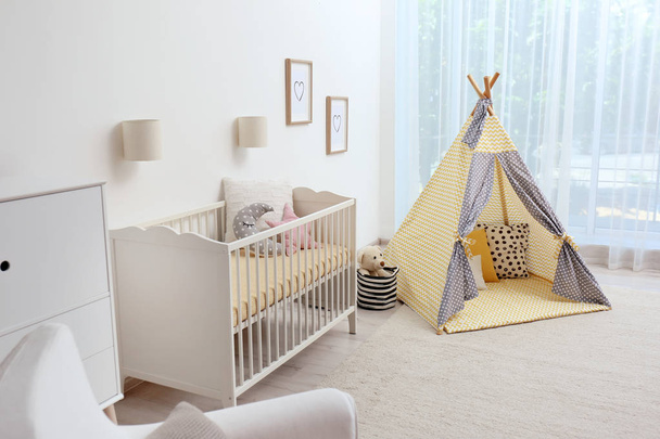 Cozy kids room interior with play tent and toys - Foto, Imagem