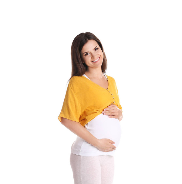 Happy pregnant woman posing on color background - Photo, Image