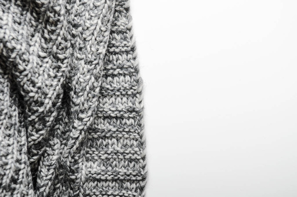 The edge of a gray knitted plaid on white background. Background, copy space. - Foto, Bild