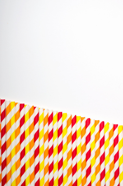 Multicolored juice straw in row on white background. copy space, top view - Photo, Image