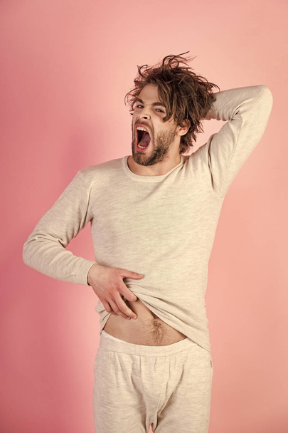 Man with disheveled hair yawn in underwear. - Фото, изображение