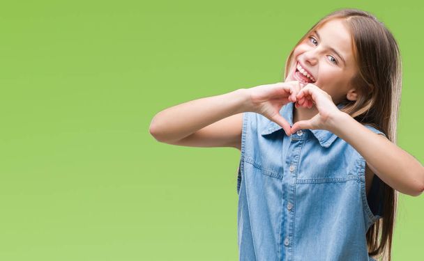 Young beautiful girl over isolated background smiling in love showing heart symbol and shape with hands. Romantic concept. - Photo, Image