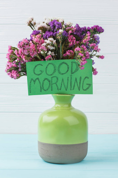 Green vase with flowers. - Photo, Image