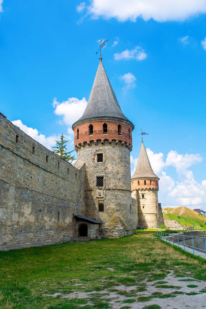 Photo of old ancient stone castle with many hight towers in Kamyanets-Podilsky - Fotó, kép