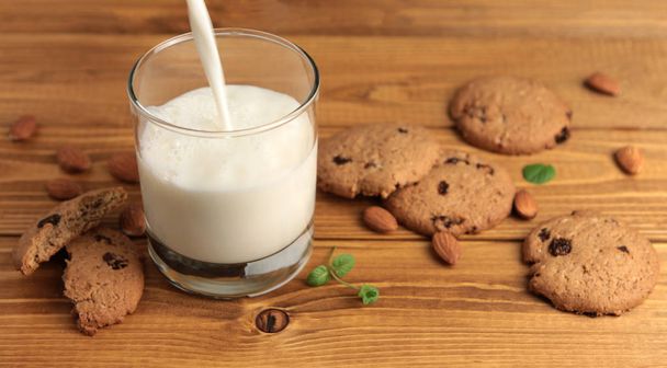 Glass of milk on a wooden background - Foto, immagini