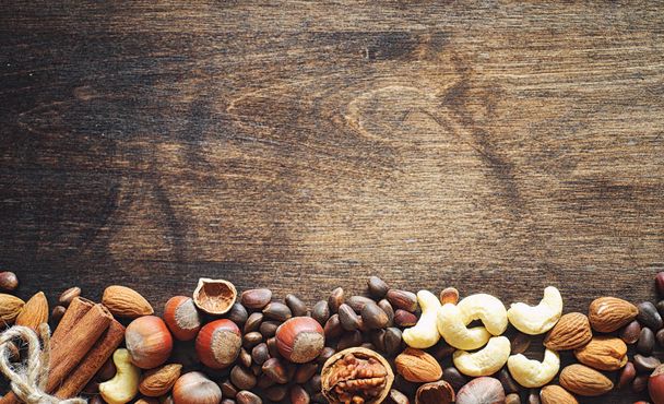 Different nuts on a wooden table. Cedar, cashew, hazelnut, walnu - Photo, Image