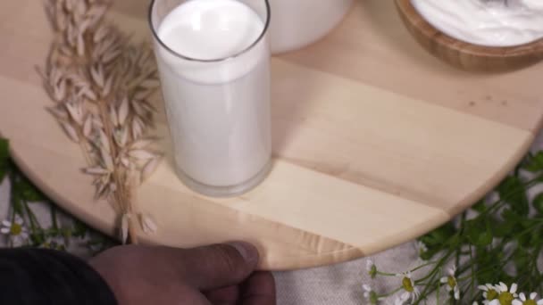 Σεφ αρσενική χέρι στροφές ξύλινο πιάτο με γαλακτοκομικά προϊόντα στο kitchen - Πλάνα, βίντεο