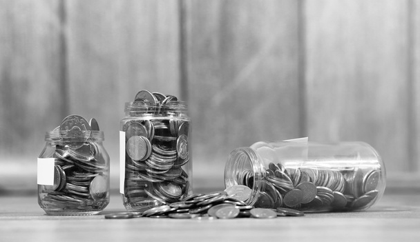 Coins in a jar on the floor. Accumulated coins on the floor. Sav - Photo, Image
