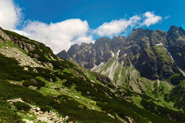 Mountain landscape against blue sky with clouds. Majestic High Tatras mountains in Slovakia. - 写真・画像