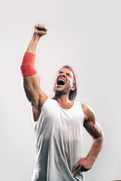 Athlete with a raised hand celebrates victory - Фото, зображення