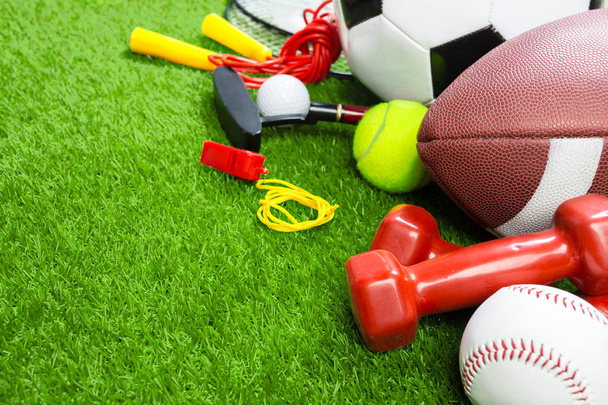 Various sport objects on green grass - Foto, imagen