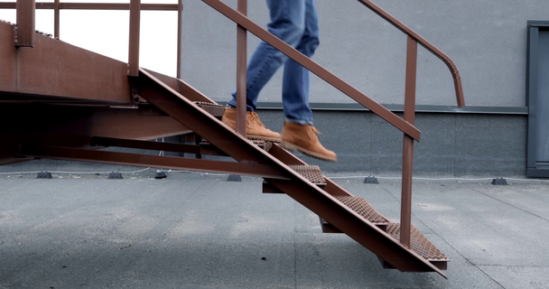 partial view of architect walking down steps on location - Footage, Video