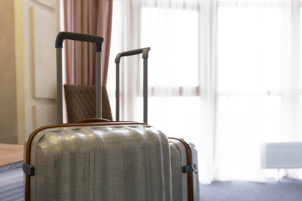 Stylish luggage bags in modern hotel room - Фото, зображення