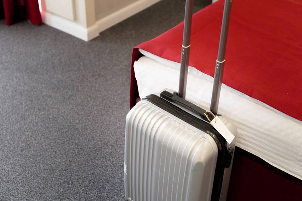 Stylish luggage bag in modern hotel room - Foto, afbeelding
