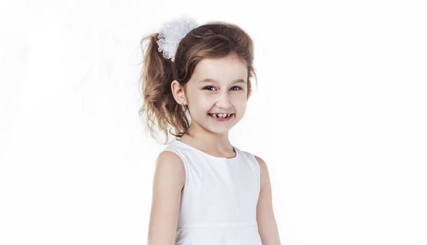 portrait of a happy six-year-old girl against white background - Фото, зображення