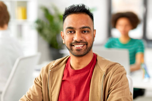 smiling indian man at office - Foto, imagen