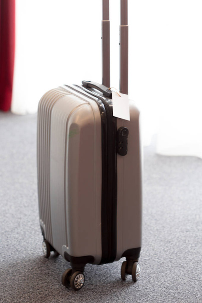 Stylish luggage bag in modern hotel room - Фото, изображение