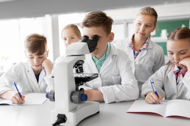 kids or students with microscope biology at school - Foto, Imagen