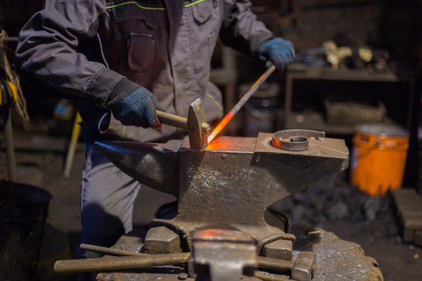 Blacksmith forging molten metal - Photo, Image
