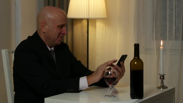 Businessman in Restaurant Text Using Mobile and Sip a Glass with Wine - Filmati, video