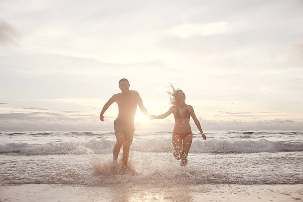 happy love couple running along the beach, healthy rest, sports activity, summer vacation - Zdjęcie, obraz