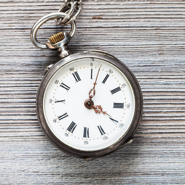 old pocket watch on gray wooden background close up - Photo, Image
