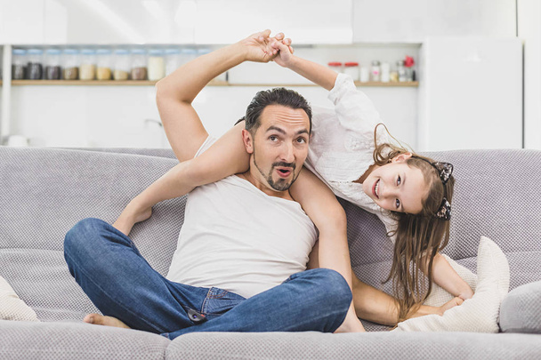 father playing with daughter at home. Happy family indoors living lifestyle - Фото, зображення