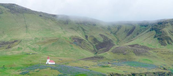 Isolated small wooden church with red roof in Vik i Myrdal- South Iceland - Fotografie, Obrázek