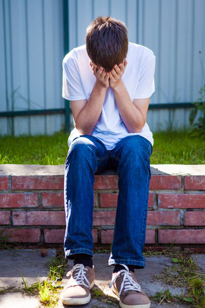 Sad Young Man sit on the City Street - Photo, Image