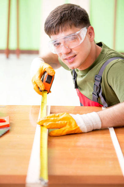 Young man carpenter working in workshop  - Fotoğraf, Görsel