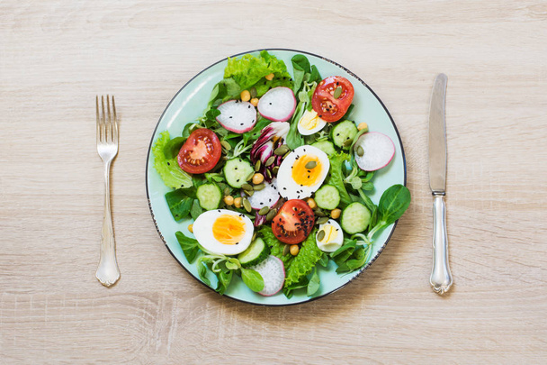 Healthy vegan lunch plate. Fresh salad with vegetables and eggs for proper nutrition. Summer food. Top view, copy space. - Photo, Image