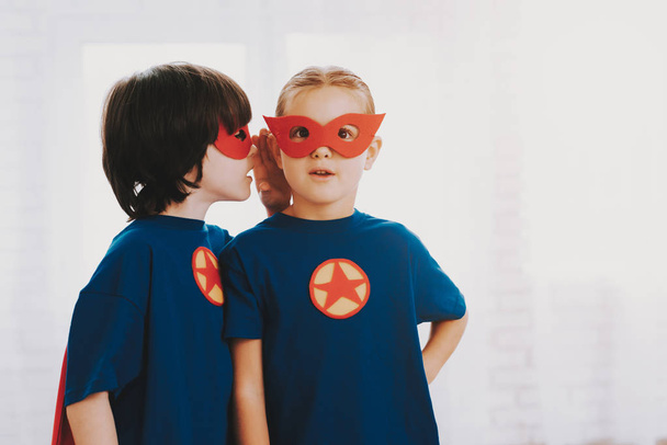 Children In A Superhero Suits. Posing Concept. Masks And A Raincoats. Bright Room. Resting Together. Save The World. Get Ready. Secret Whispering. Happy Childhood. Brother And Sister. Young Leaders. - Фото, изображение
