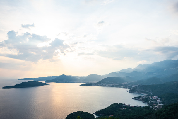 aerial view of Budva riviera and Adriatic sea during sunset in Montenegro - Photo, Image